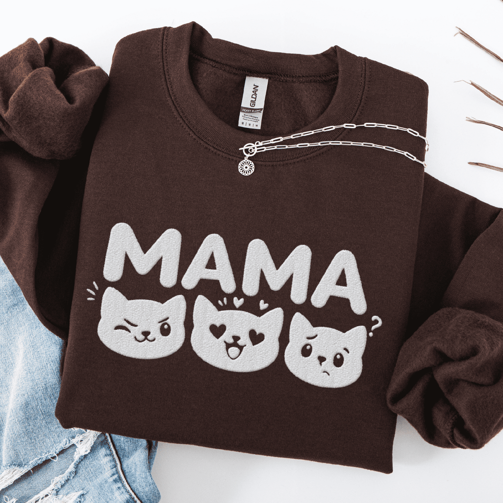 Dark Chocolate mama embroidered sweatshirt with cat face design, folded flat on light denim
