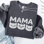 Dark Heather mama embroidered sweatshirt with cat face design, folded flat on light denim