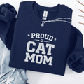 Navy proud cat mom embroidered sweatshirt with “Proud Cat Mom” text, folded flat on light denim