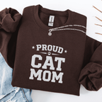 Dark Chocolate proud cat mom embroidered sweatshirt with “Proud Cat Mom” text, folded flat on light denim