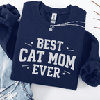 Navy cat mom embroidered sweatshirt with “Best Cat Mom Ever” text, styled flat on light denim