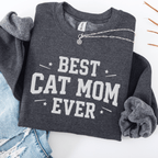 Dark heather cat mom embroidered sweatshirt with “Best Cat Mom Ever” text, styled flat on light denim