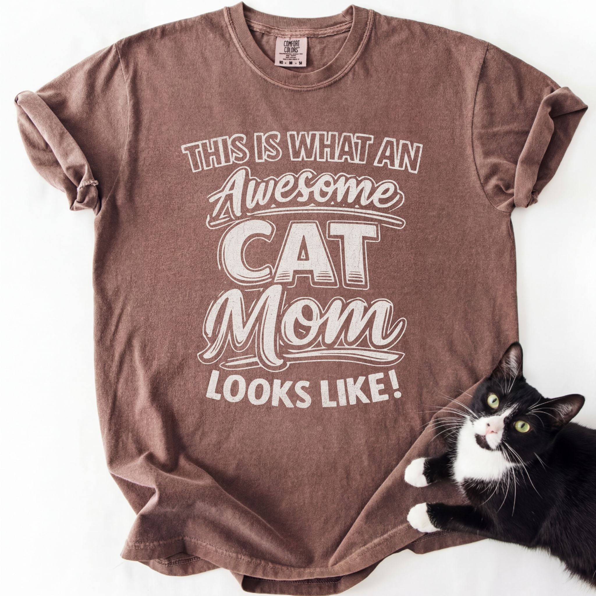 Espresso cat mom t shirt with “This Is What an Awesome Cat Mom Looks Like” design and black and white cat beside the shirt