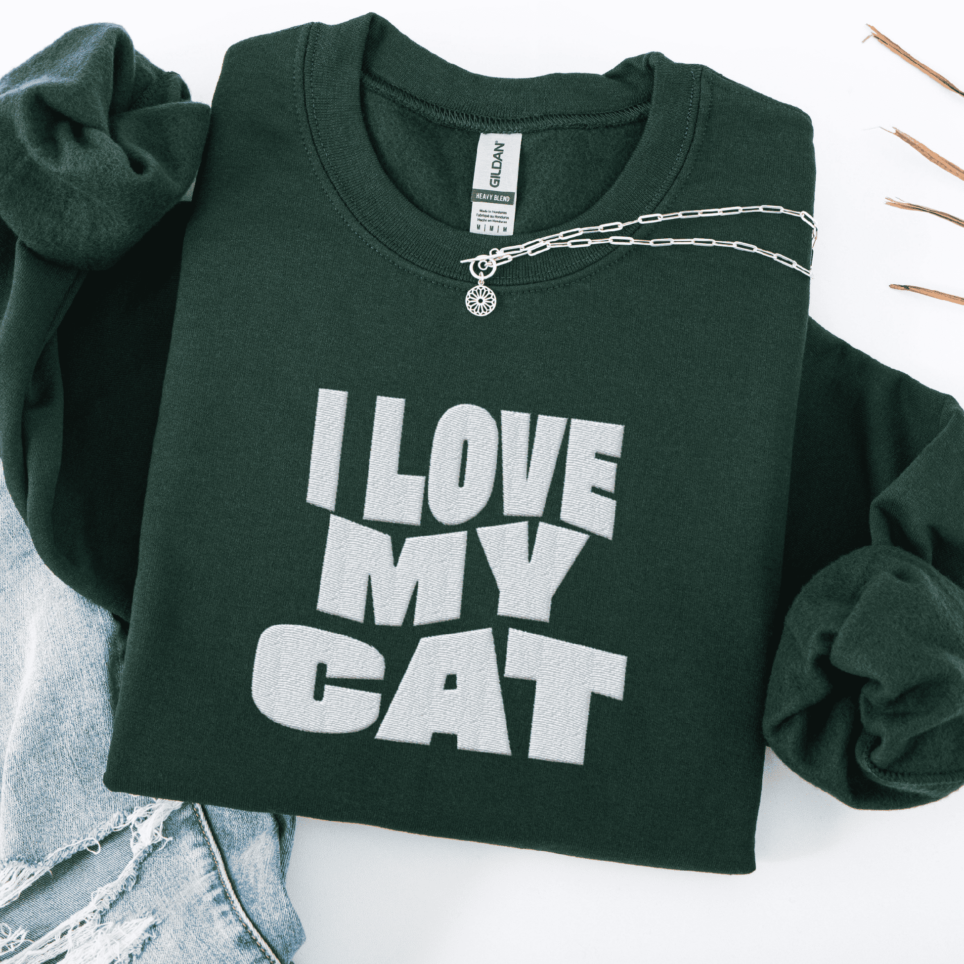 Forest Green embroidered cat sweatshirt with the phrase “I Love My Cat” shown folded flat