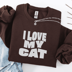 Dark Chocolate embroidered cat sweatshirt with the phrase “I Love My Cat” shown folded flat