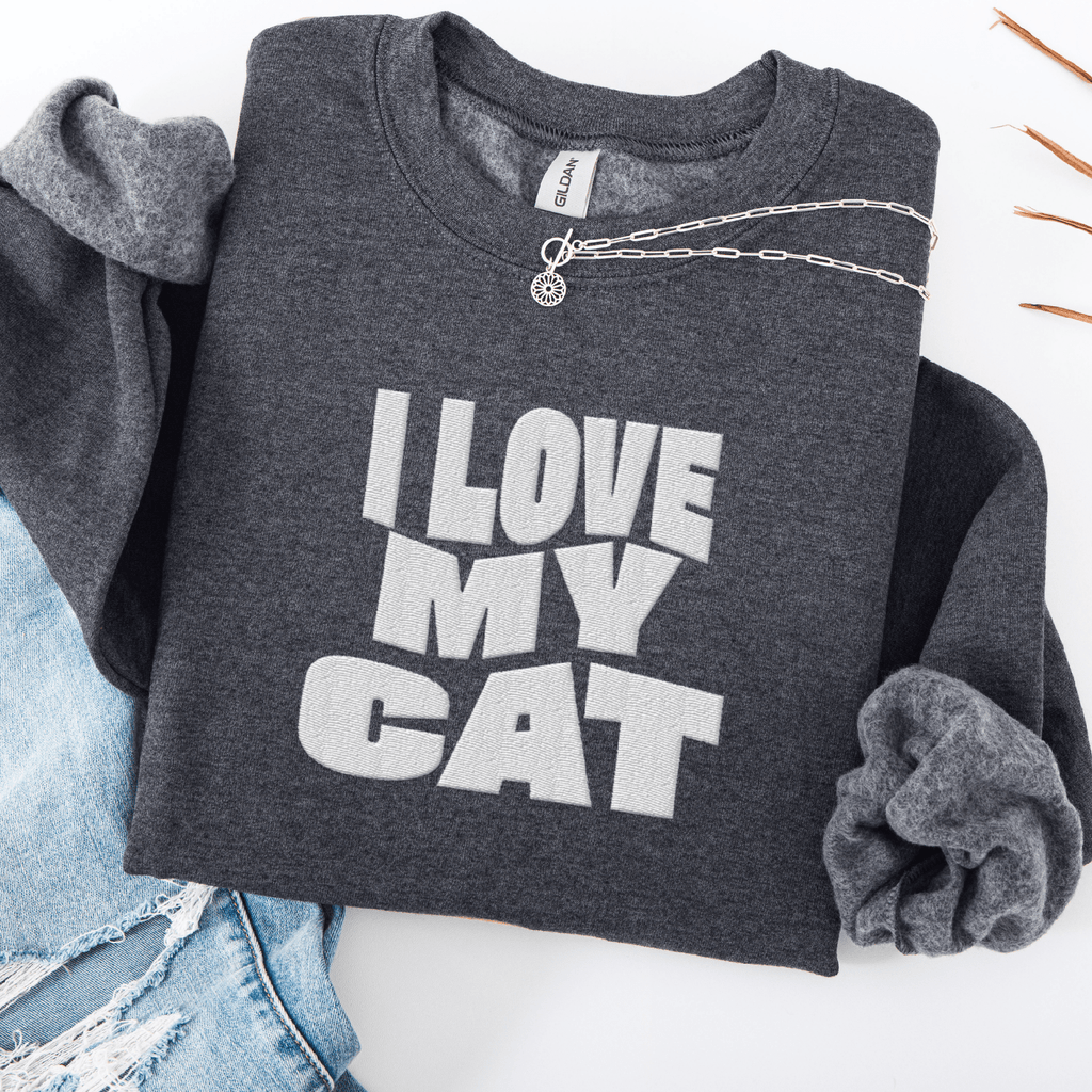 Dark Heather embroidered cat sweatshirt with the phrase “I Love My Cat” shown folded flat