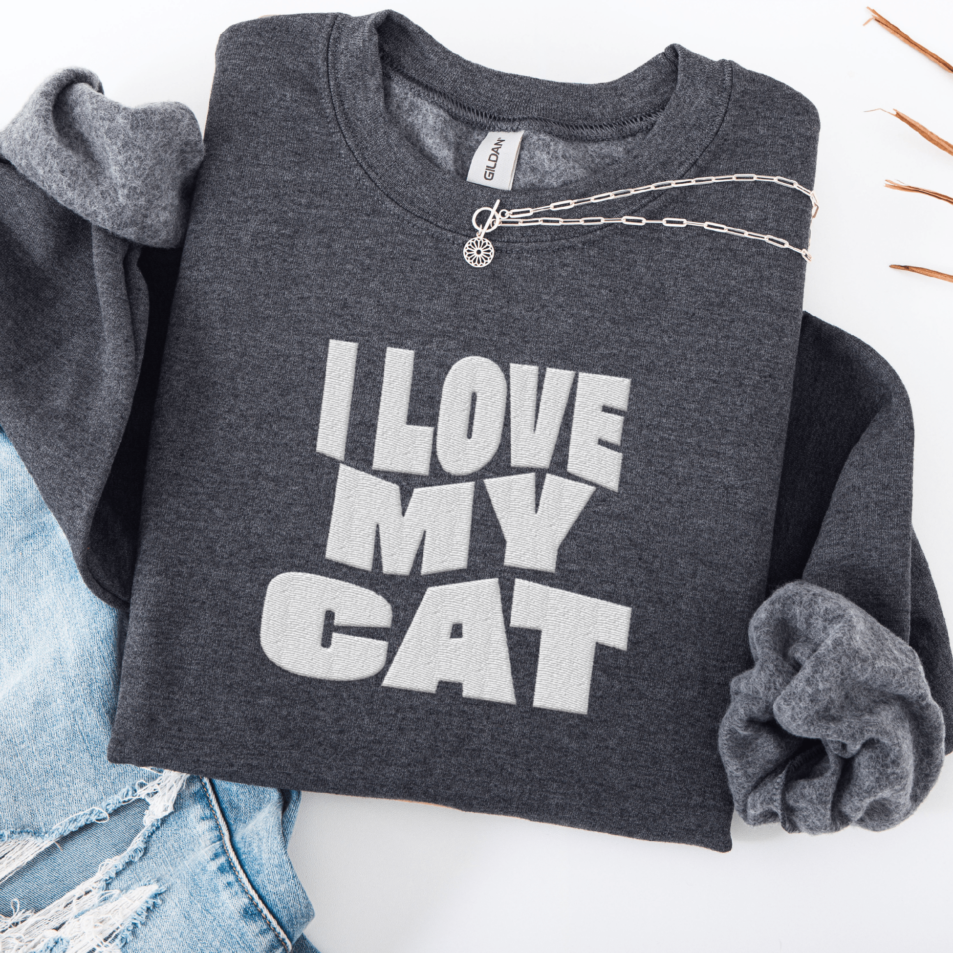 Dark Heather embroidered cat sweatshirt with the phrase “I Love My Cat” shown folded flat