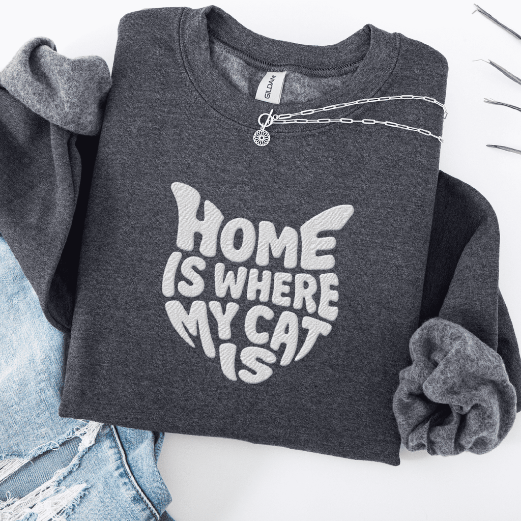 Dark Heather embroidered cat sweatshirt with the phrase “Home Is Where My Cat Is” shown folded flat