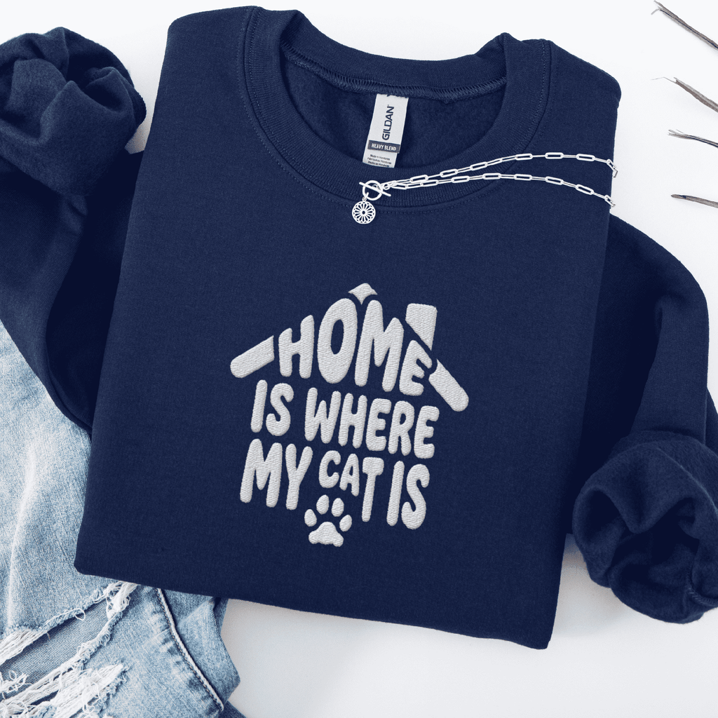 Navy embroidered cat sweatshirt with the phrase “Home Is Where My Cats Are” shown folded flat