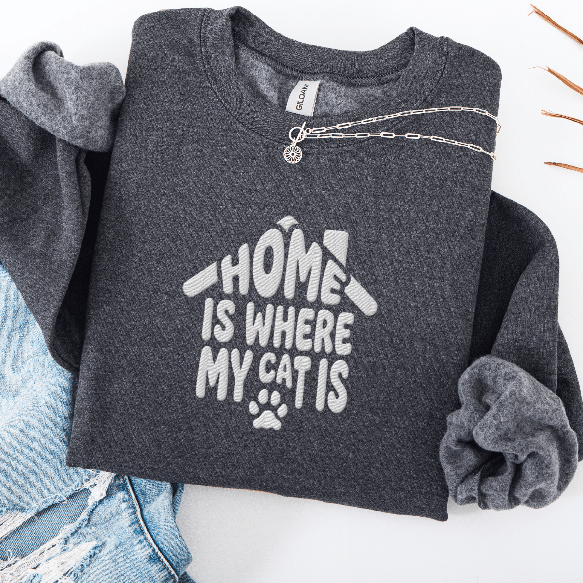 Dark Heather embroidered cat sweatshirt with the phrase “Home Is Where My Cats Are” shown folded flat