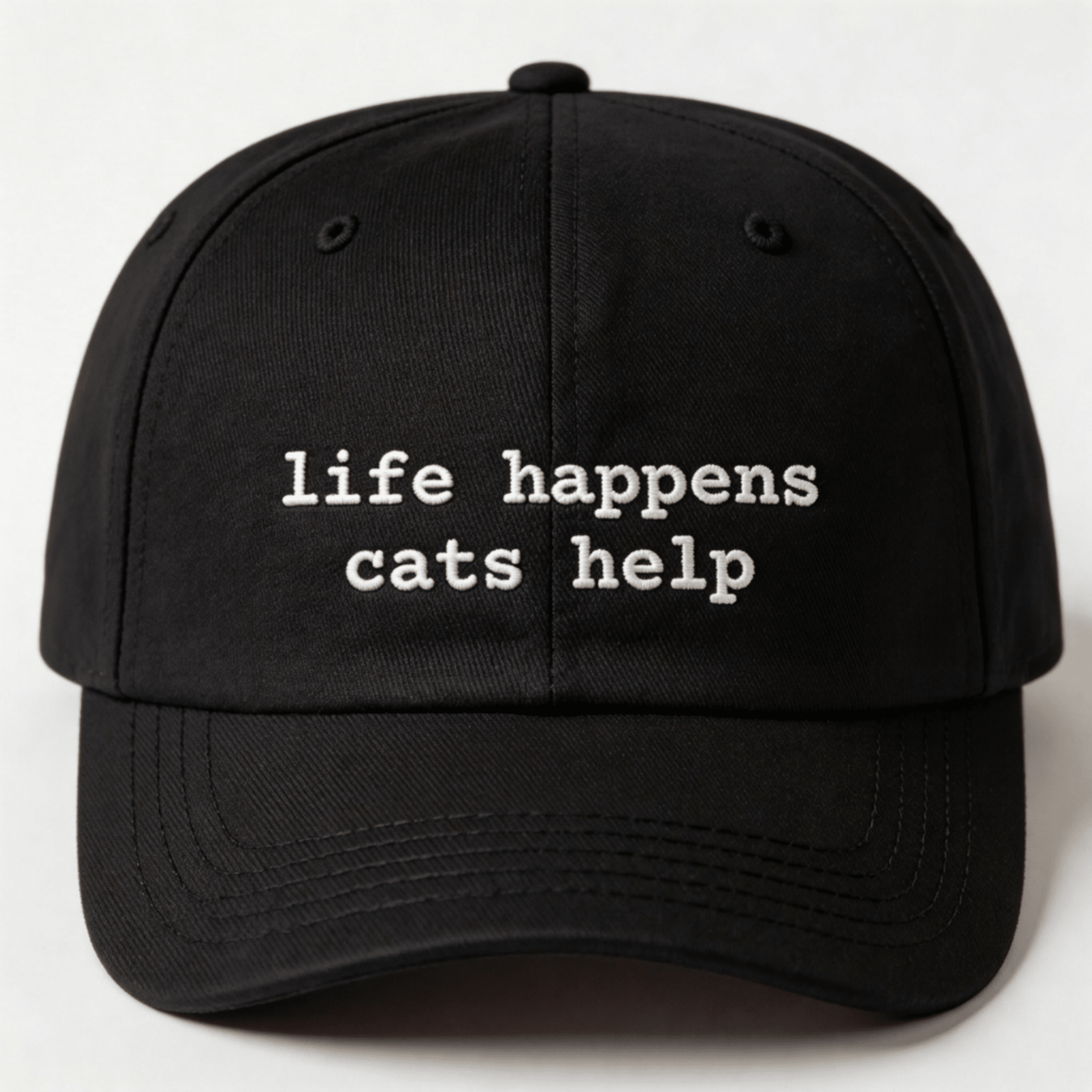 Black embroidered cap with the phrase “life happens cats help” shown from the front