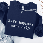 Navy embroidered cat sweatshirt with the phrase “life happens cats help” shown folded flat