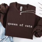Dark Chocolate embroidered cat sweatshirt with the phrase “queen of cats” shown folded flat