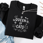 Black embroidered cat sweatshirt with “Queen of Cats” text and cat-themed doodle icons shown folded flat