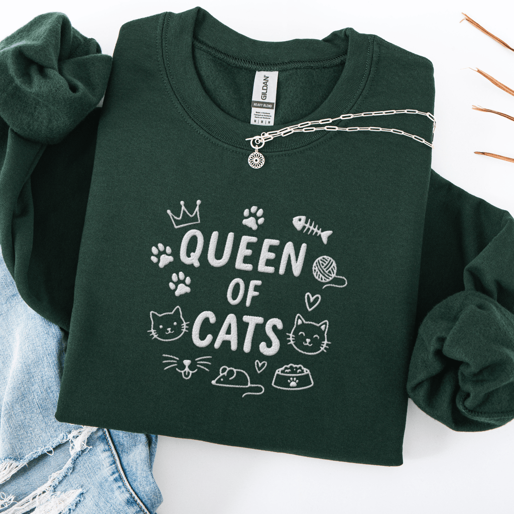 Forest Green embroidered cat sweatshirt with “Queen of Cats” text and cat-themed doodle icons shown folded flat
