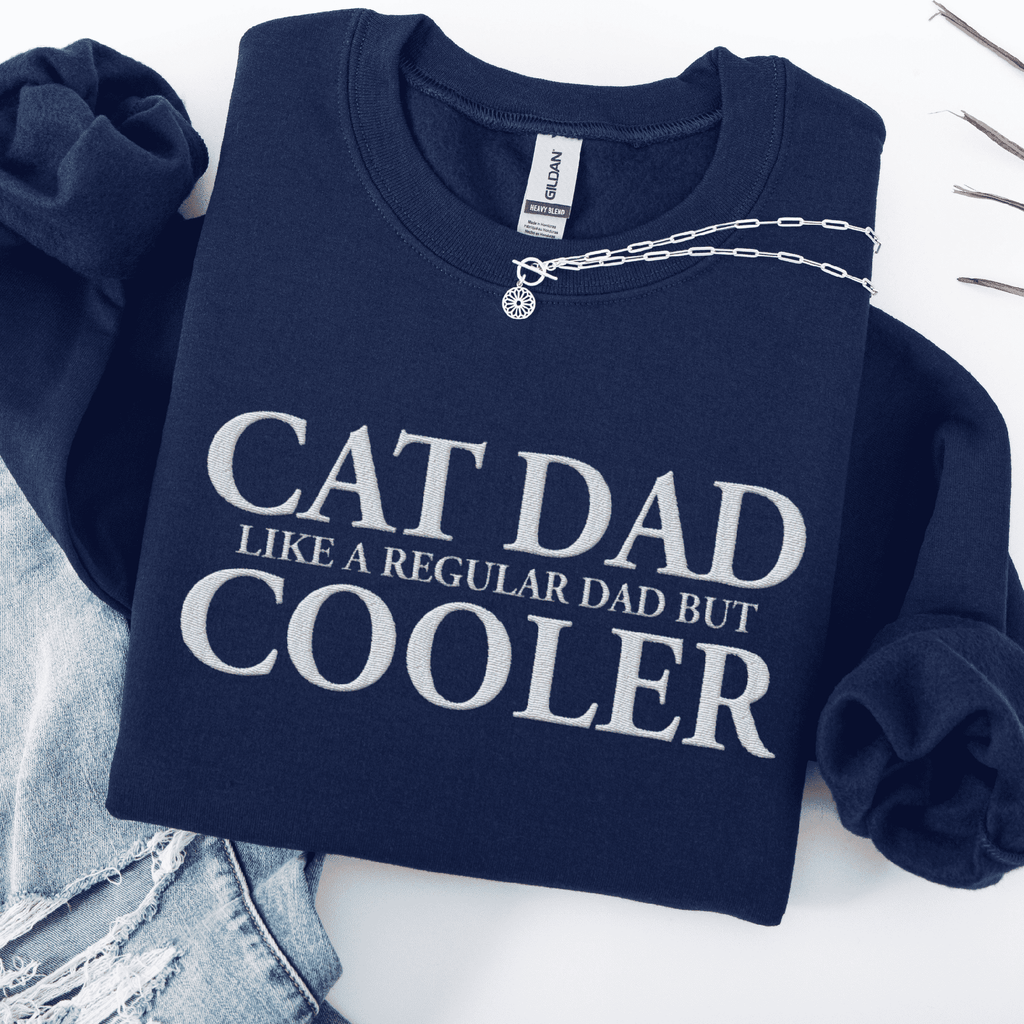 Navy embroidered cat dad sweatshirt folded flat with CAT DAD COOLER text