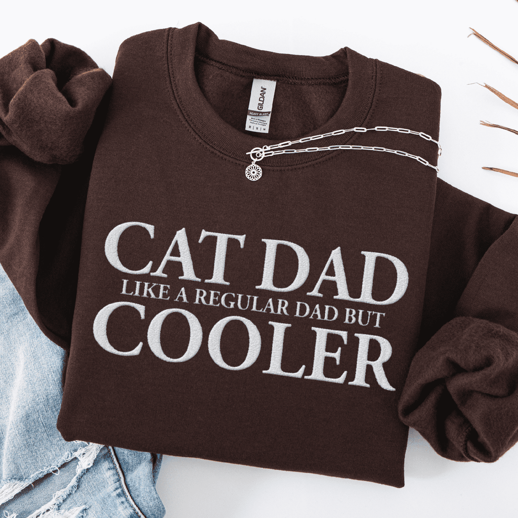 Dark chocolate embroidered cat dad sweatshirt folded flat with CAT DAD COOLER text