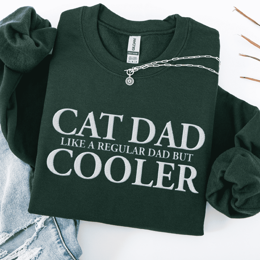 Forest green embroidered cat dad sweatshirt folded flat with CAT DAD COOLER text