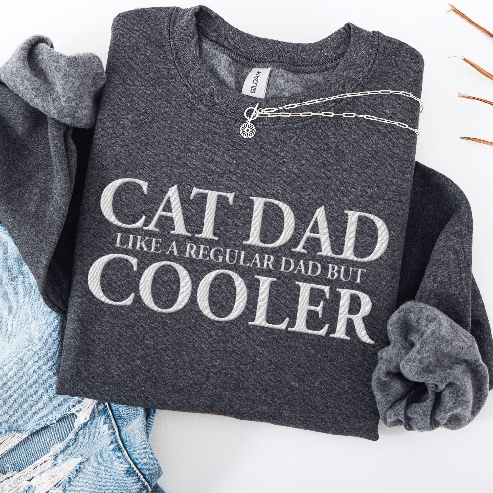 Dark heather embroidered cat dad sweatshirt folded flat with CAT DAD COOLER text