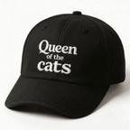 Black cap with white Queen of the Cats embroidery shown at an angle