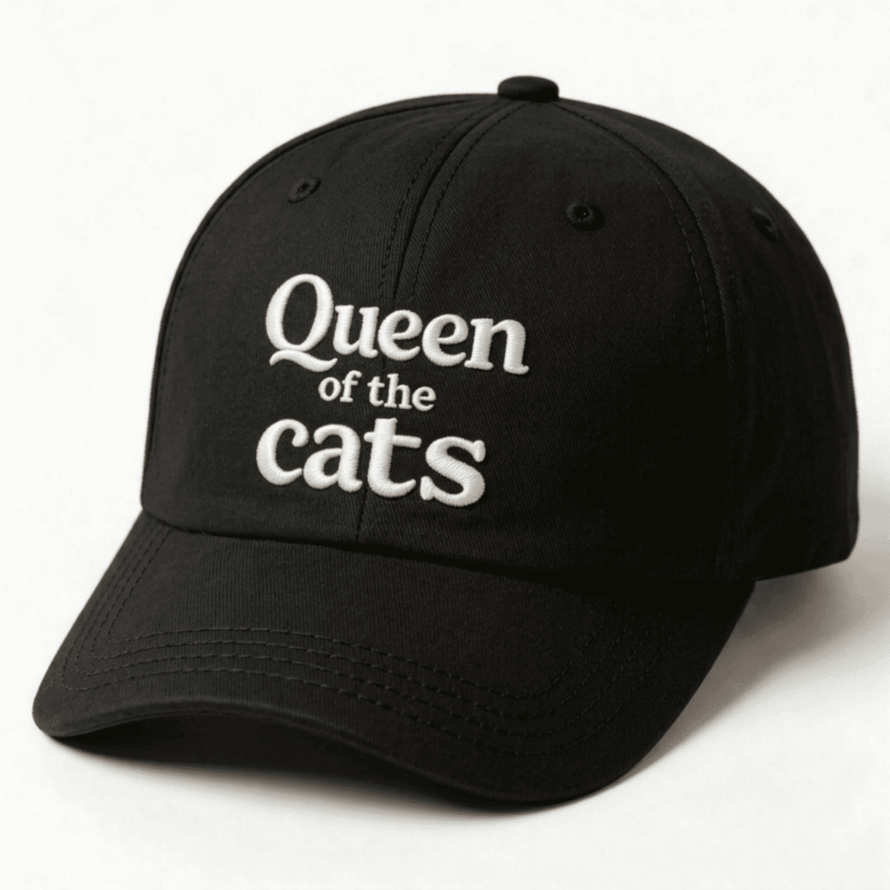 Black cap with white Queen of the Cats embroidery shown at an angle