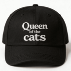 Black cap with white Queen of the Cats embroidery shown from the front