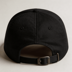 Back view of a black embroidered cap with adjustable strap and metal buckle