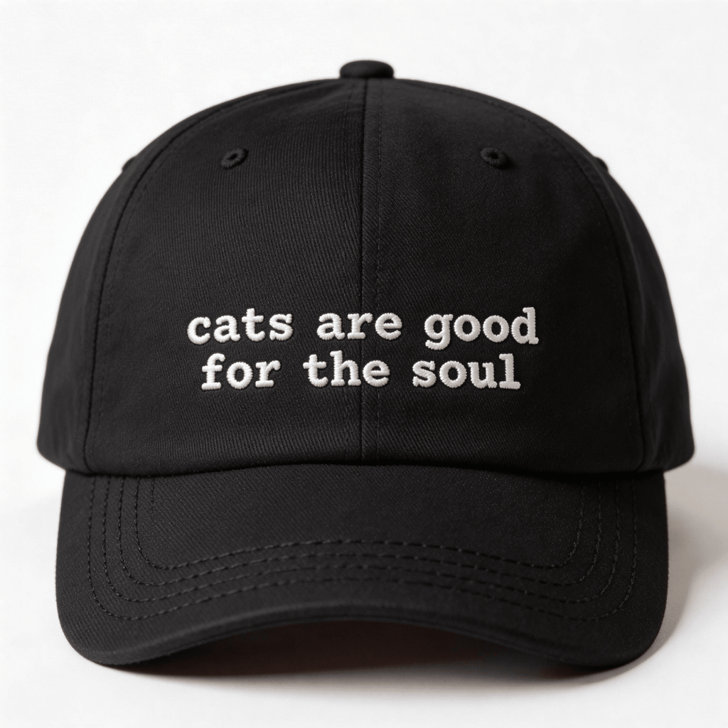 Front view of a black embroidered cap with the phrase cats are good for the soul in white lettering