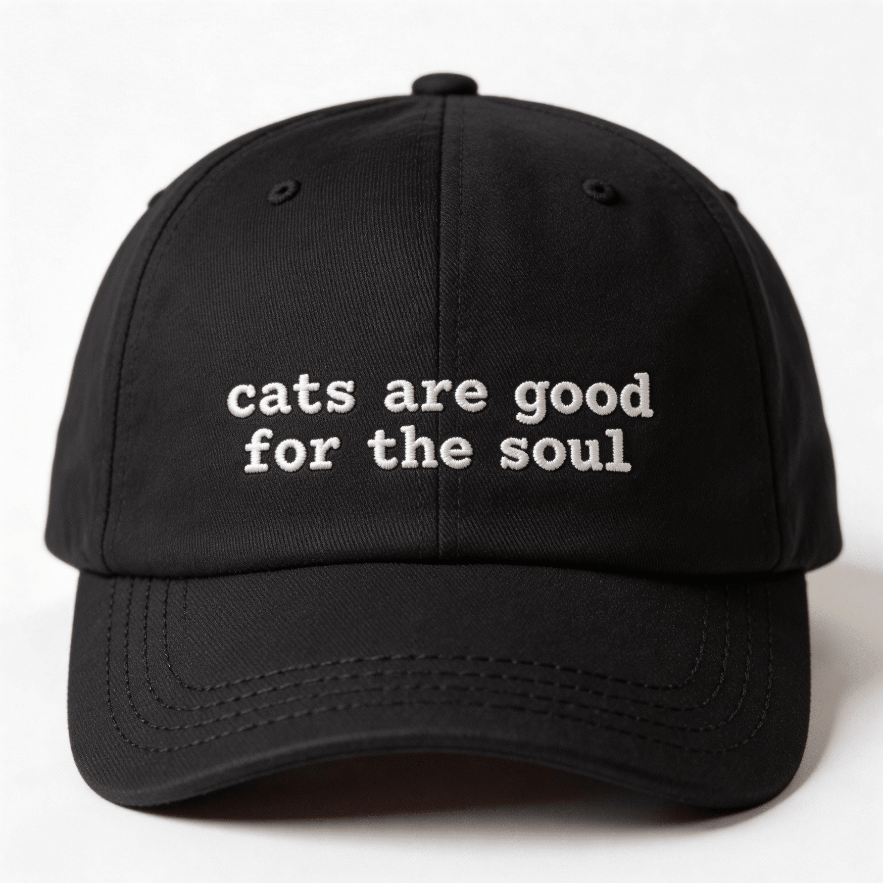 Front view of a black embroidered cap with the phrase cats are good for the soul in white lettering