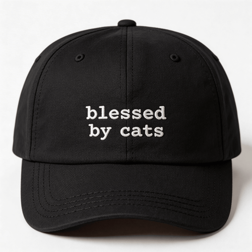 Black embroidered cap with the phrase blessed by cats stitched in white on the front