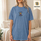 Woman wearing a blue jean embroidered funny cat t shirt with Commit Shenanigans cat design while standing indoors
