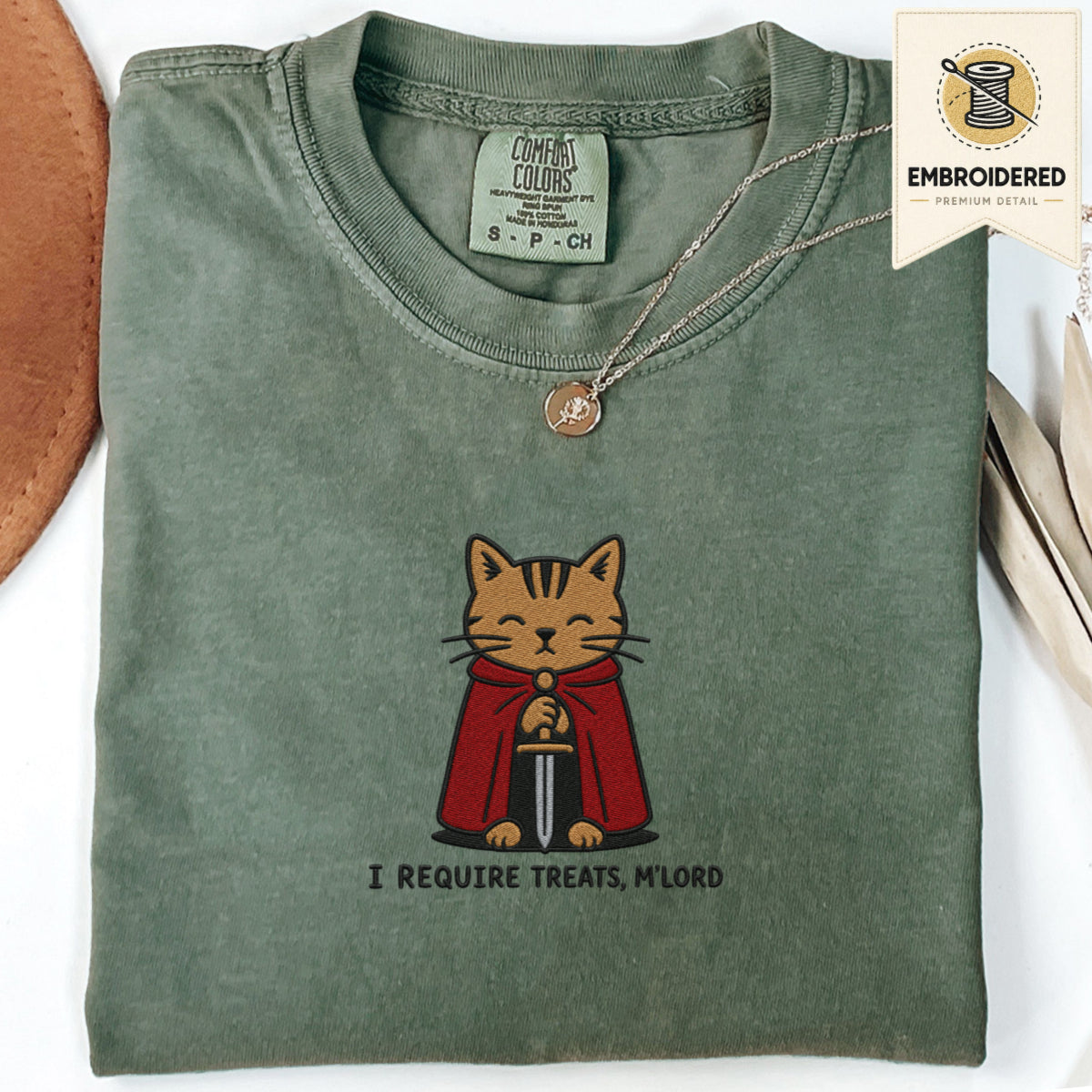 Moss green embroidered funny cat t shirt with Require Treats text and orange cat design