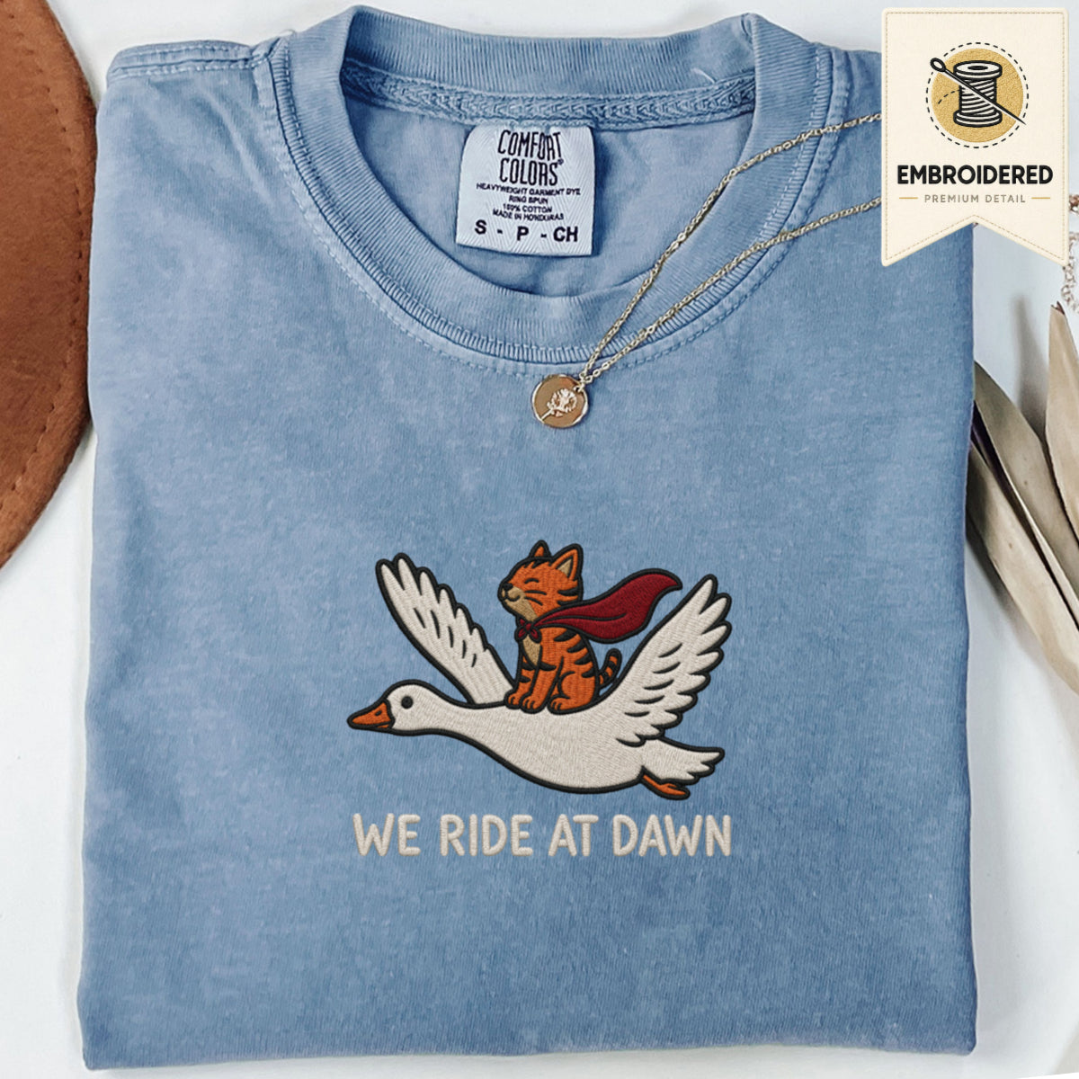 Blue jean embroidered funny cat t shirt with We Ride At Dawn winged cat design