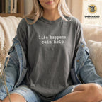 Woman wearing a pepper gray embroidered funny cat t shirt with Life Happens Cats Help text while sitting indoors