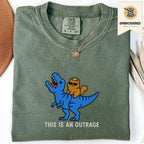 Moss green embroidered funny cat t shirt with This Is An Outrage text and blue cat carrying orange cat design