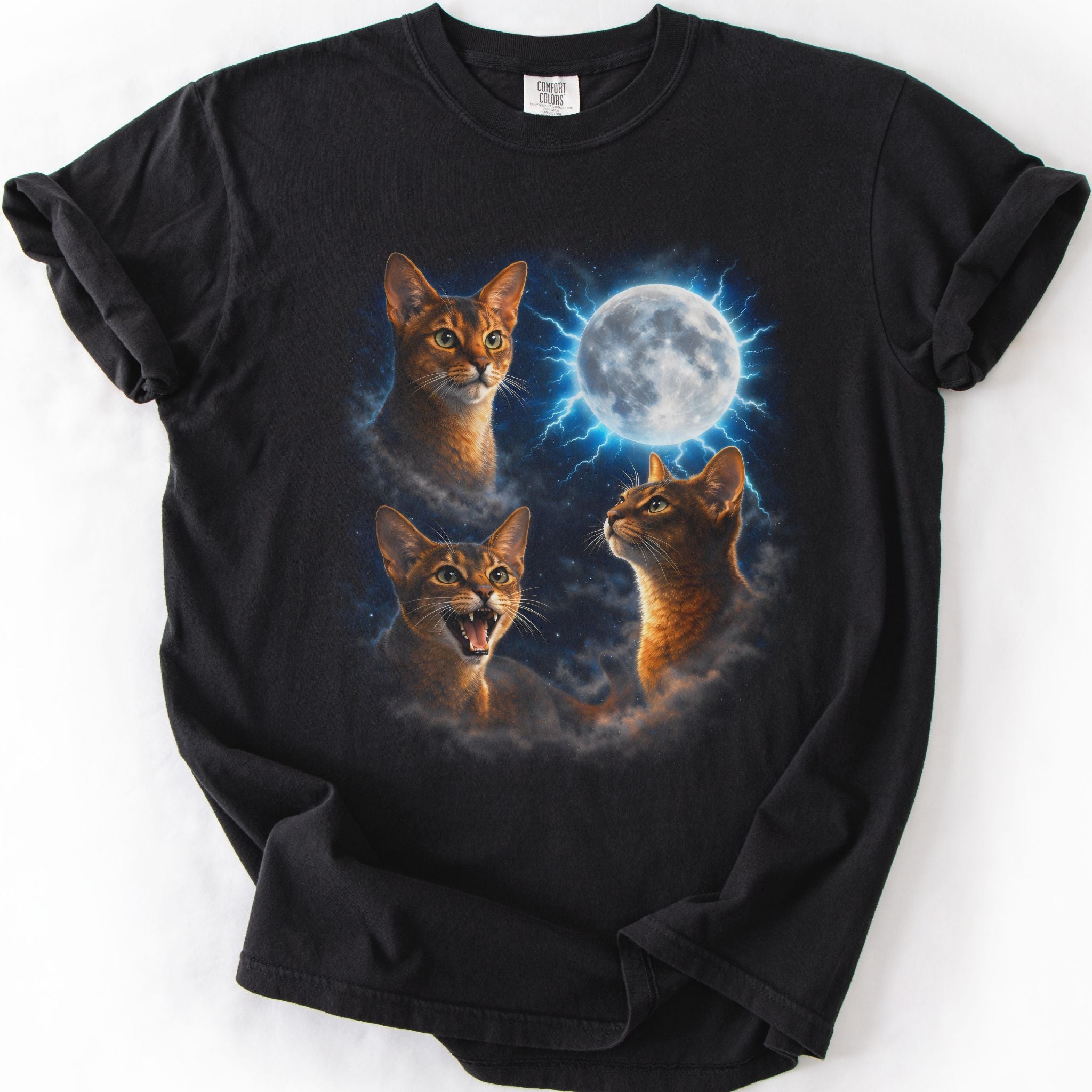 Black graphic cat t shirt with moonlit Abyssinian cat artwork and glowing full moon, folded flat
