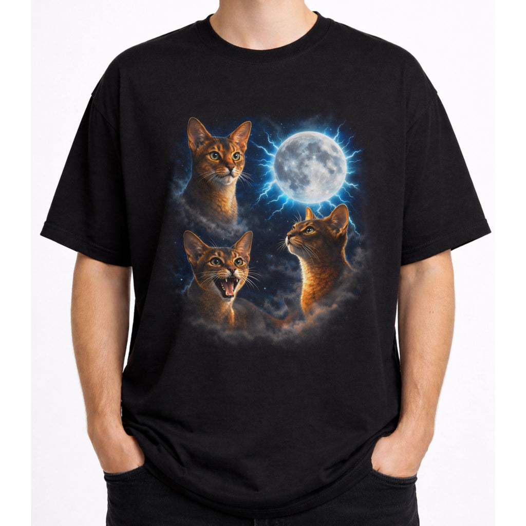 Model wearing a black graphic cat tee with moonlit Abyssinian cat design and full moon artwork