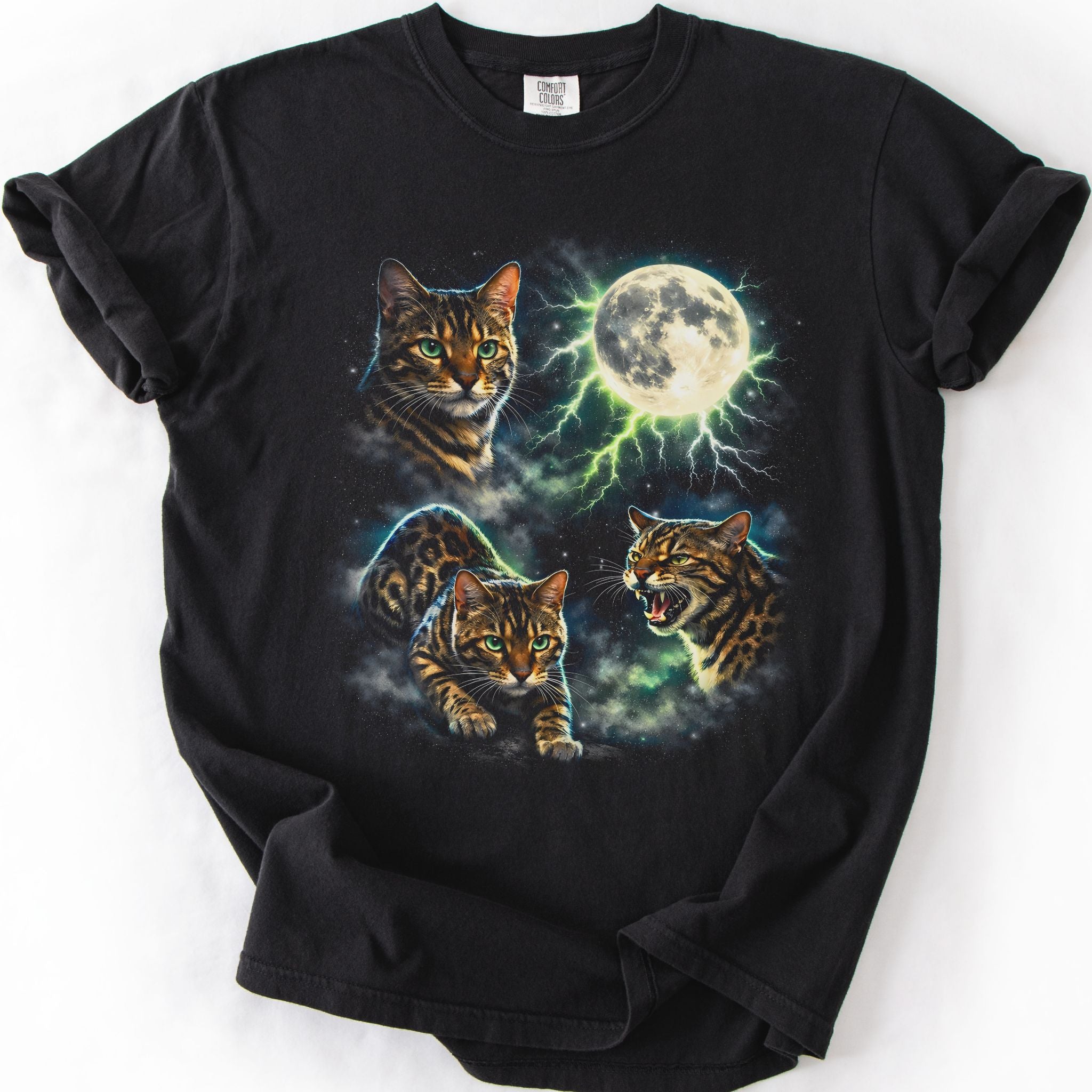 Black graphic cat t shirt with moonlit Bengal cat artwork and glowing full moon, folded flat