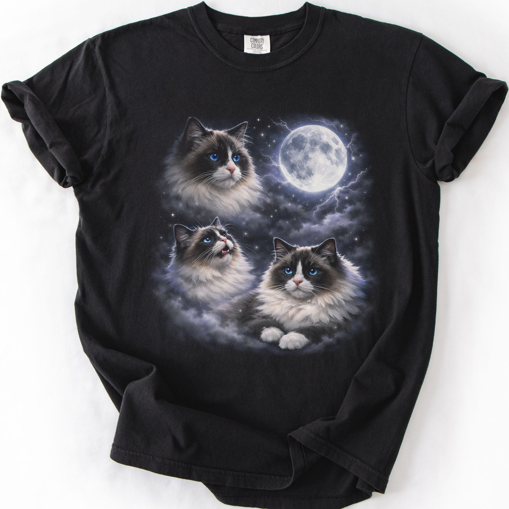 Black graphic cat t shirt with moonlit Ragdoll cat artwork and glowing full moon, folded flat
