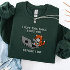 Forest green embroidered cat sweatshirt with orange cat sitting at a laptop, I Hope This Email Finds You Before I Do text, flat lay