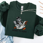 Forest green embroidered cat sweatshirt with cool grey cat in sunglasses riding a goose, Born to Honk text, flat lay