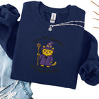Navy embroidered cat sweatshirt with orange tabby in purple wizard robe and hat, Off to Commit Shenanigans text, flat lay