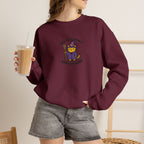 Model wearing maroon Commit Shenanigans embroidered cat sweatshirt, holding iced coffee