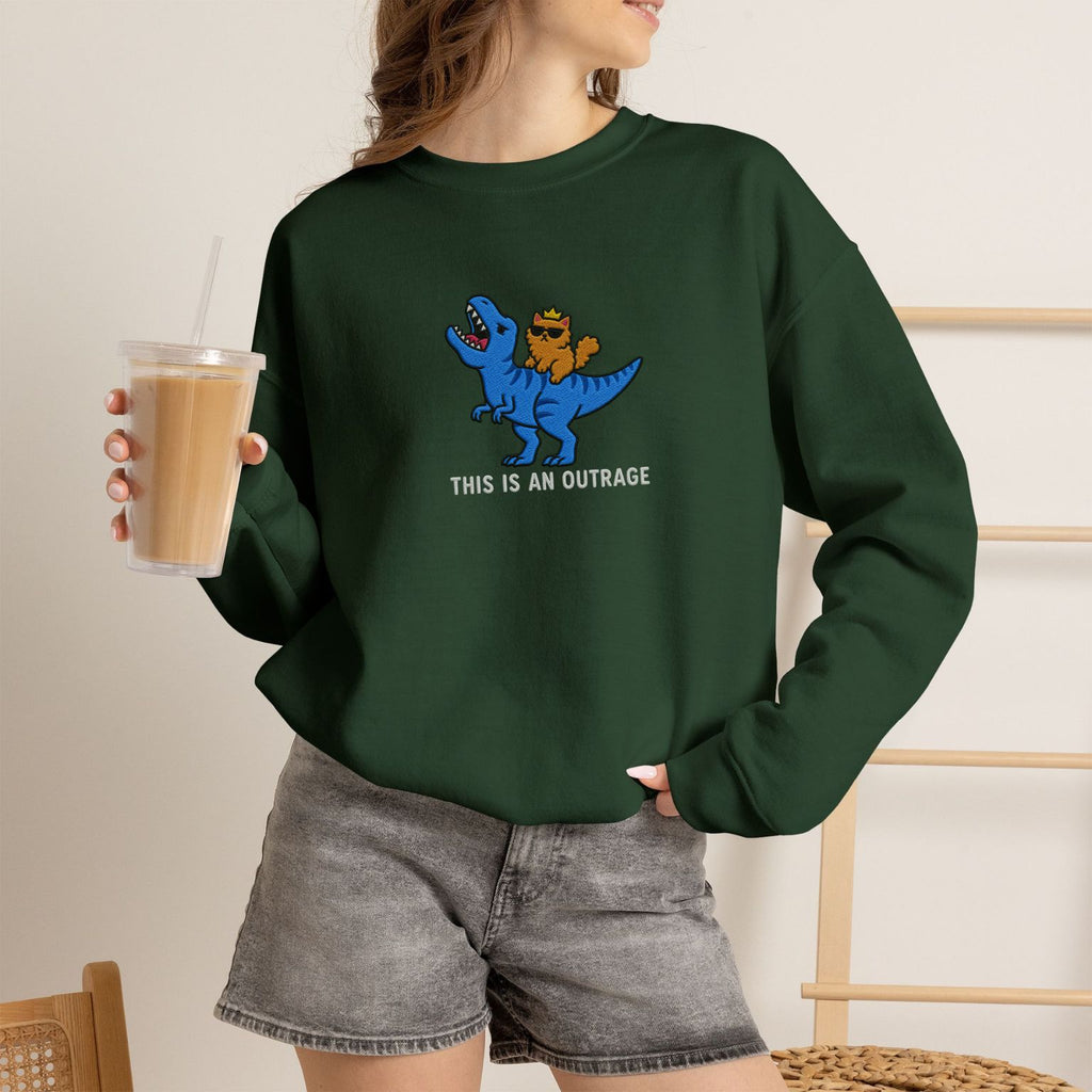 Model wearing forest green This Is An Outrage embroidered cat sweatshirt, holding iced coffee