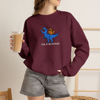 Model wearing maroon This Is An Outrage embroidered cat sweatshirt, holding iced coffee