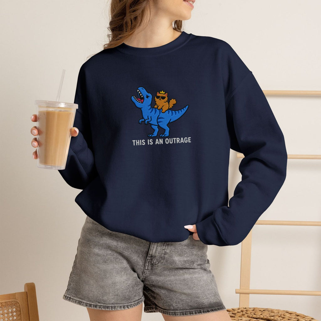 Model wearing navy This Is An Outrage embroidered cat sweatshirt, holding iced coffee