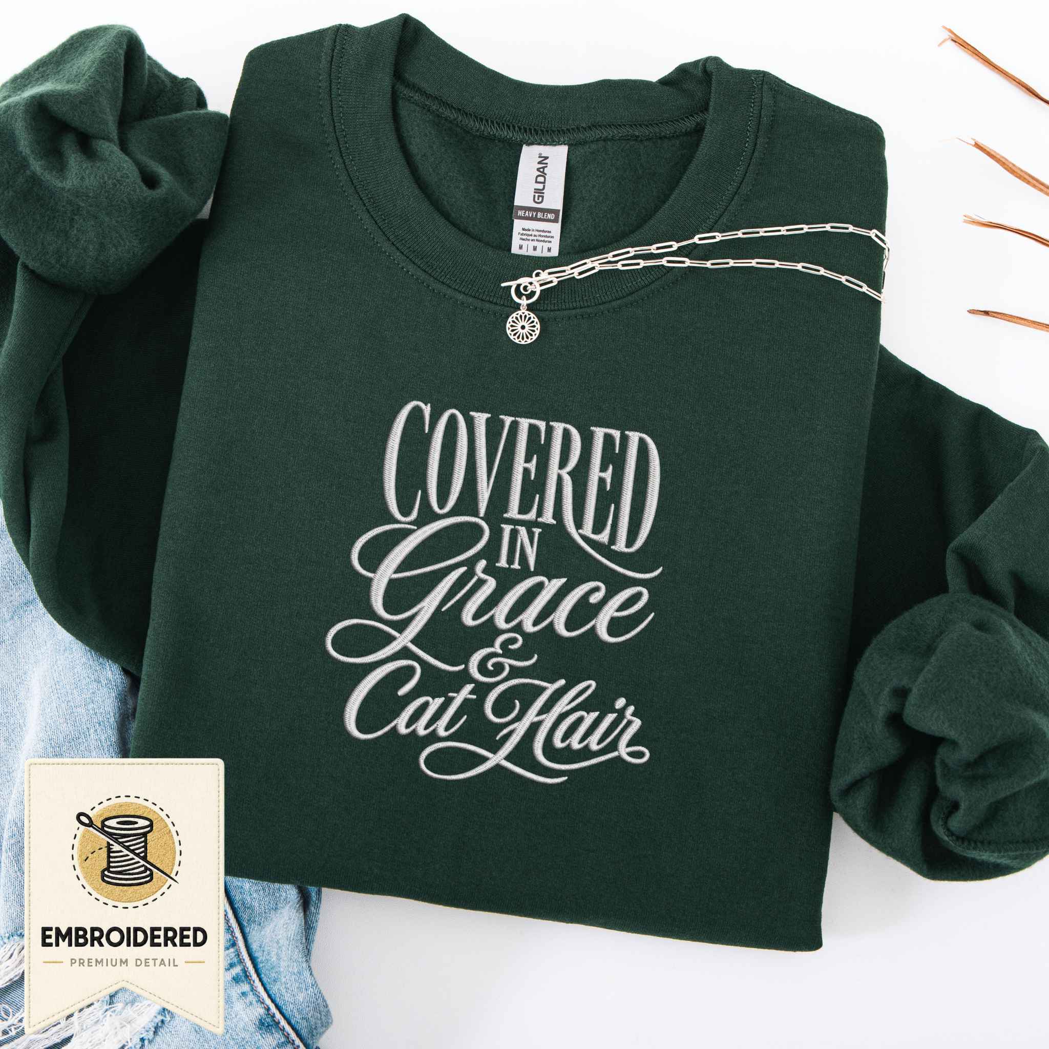 Navy embroidered cat sweatshirt with a Covered in Grace design, shown flat