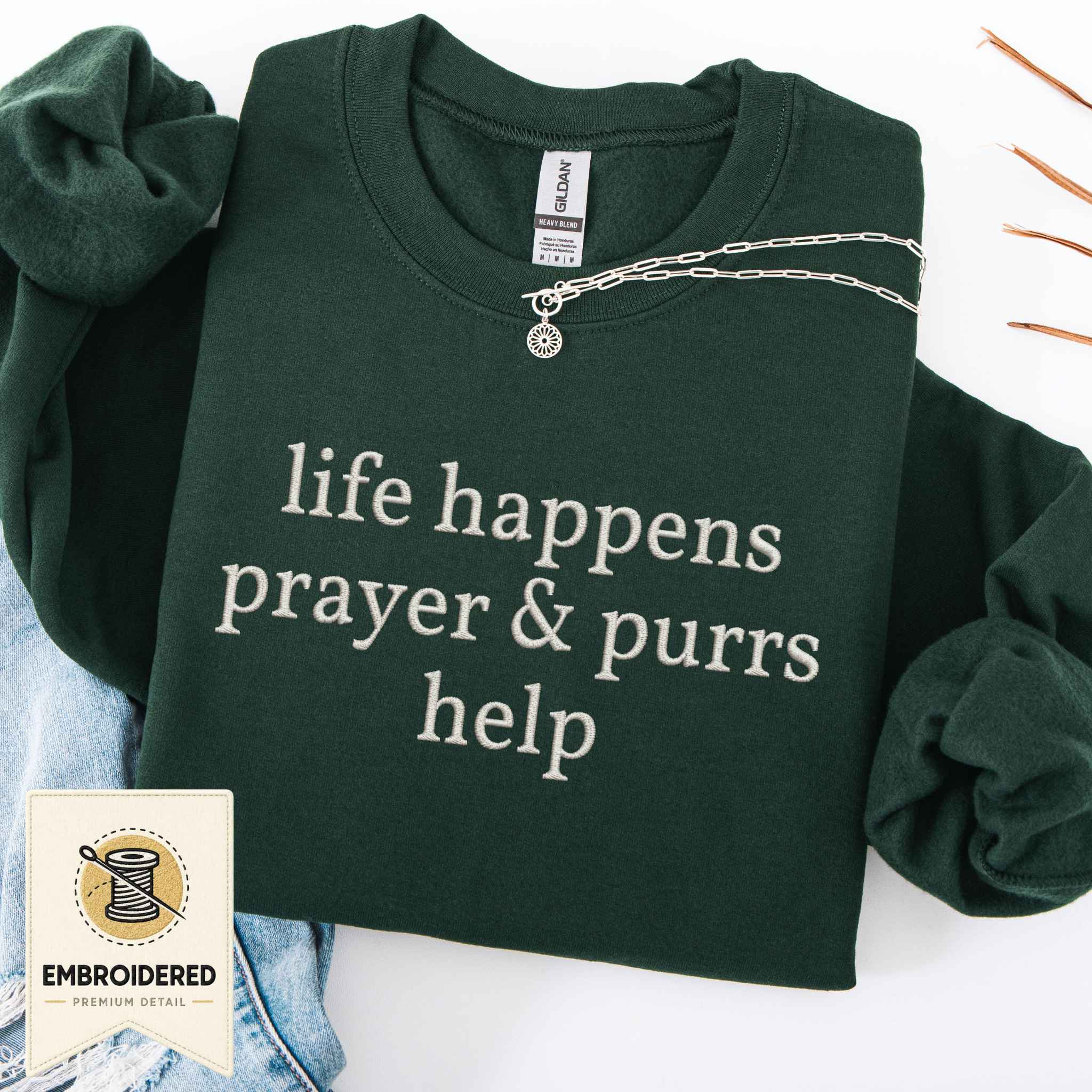 Maroon embroidered cat sweatshirt with a Prayer and Purrs Help design, shown flat