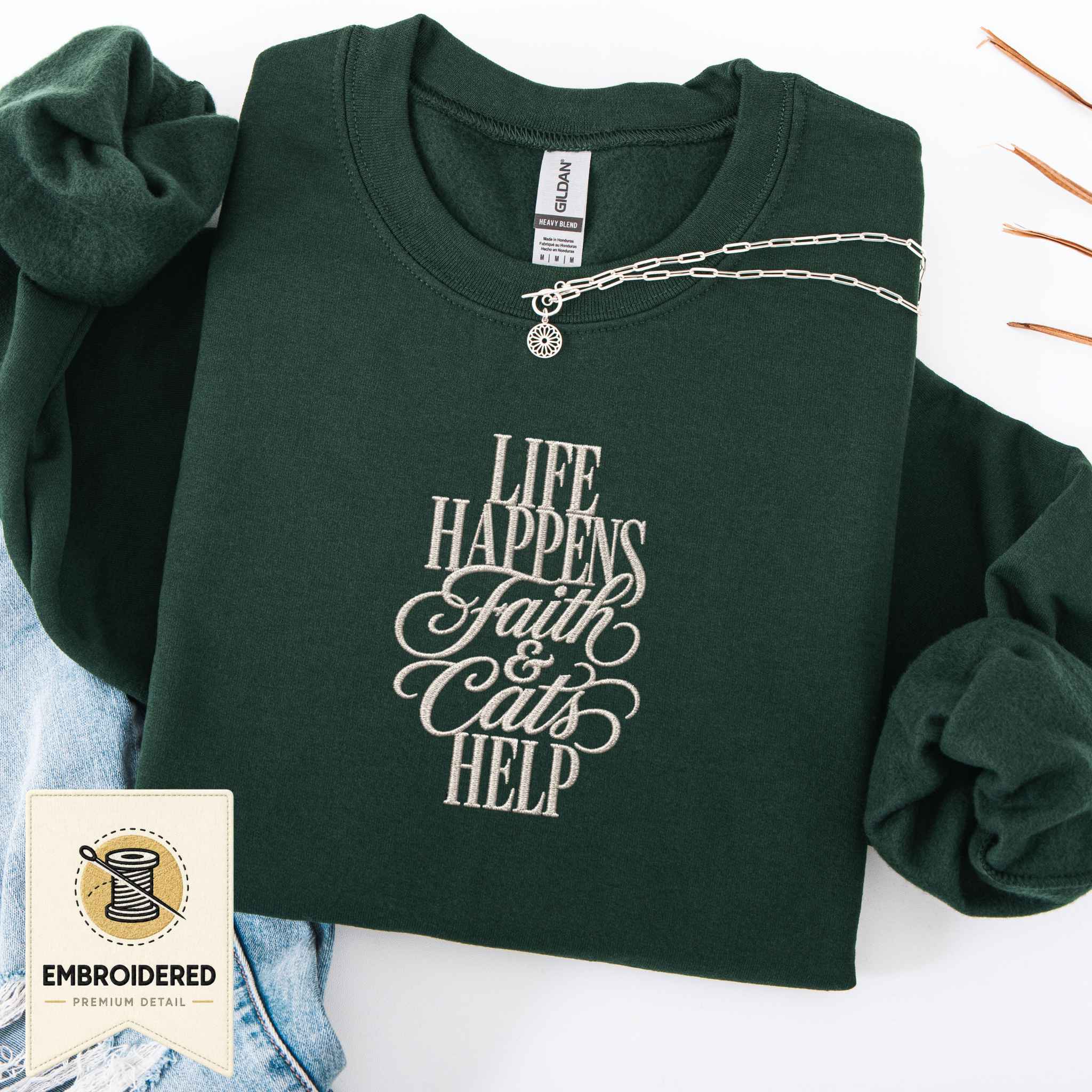 Forest green embroidered cat sweatshirt with a small Life Happens Faith and Cats Help chest design, shown flat