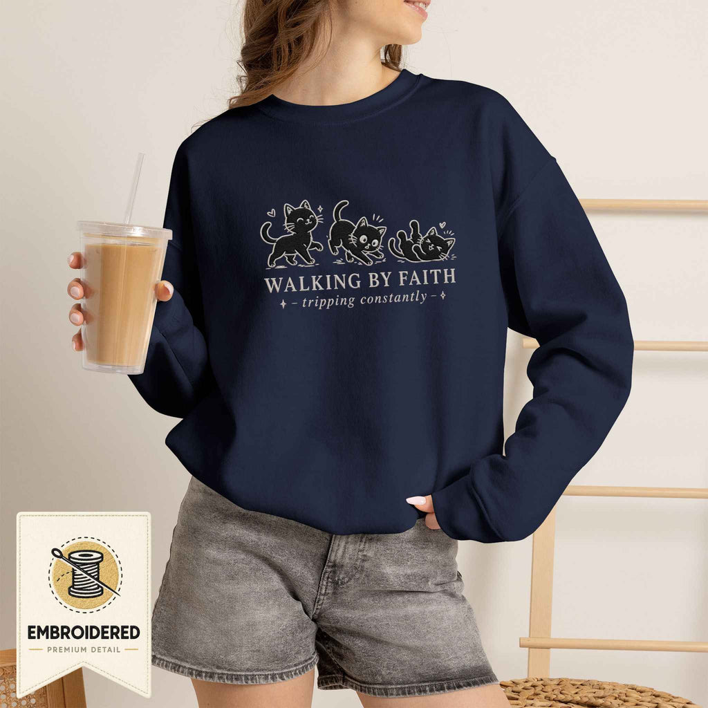Woman wearing a navy embroidered Walking by Faith cat sweatshirt